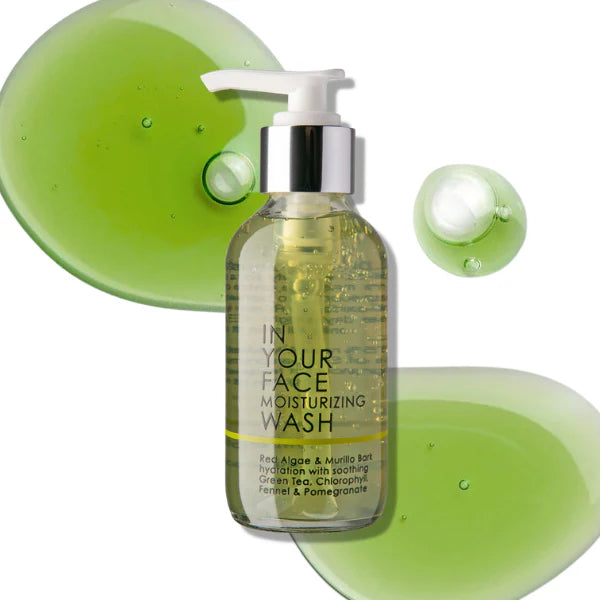 Bottle of 'In Your Face' moisturizing wash with green gel samples on a white background