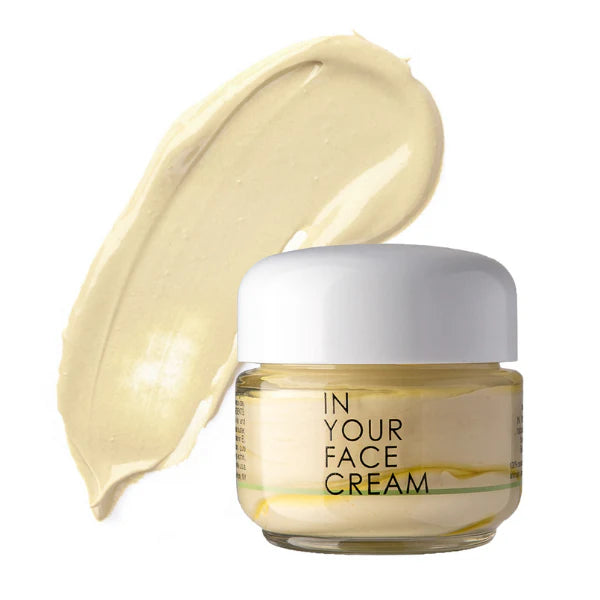 Jar of 'In Your Face Cream' with a swatch of cream on a white background