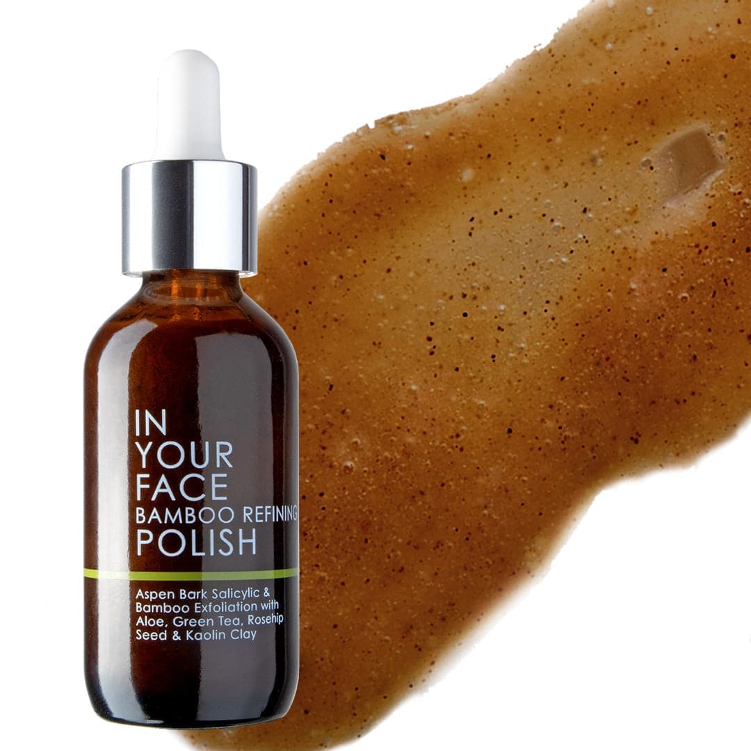 Bottle of 'In Your Face Bamboo Refining Polish' with a brown exfoliant on a white background
