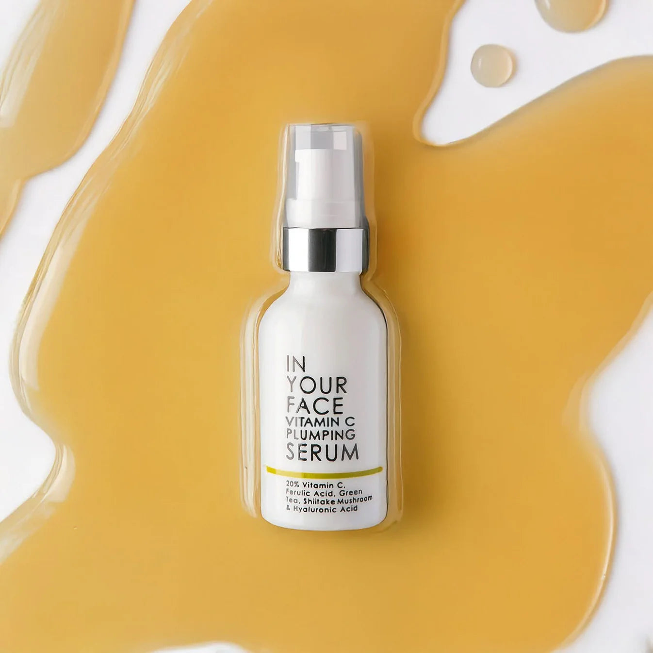 Skincare serum bottle labeled 'In Your Face' on a yellow and white background