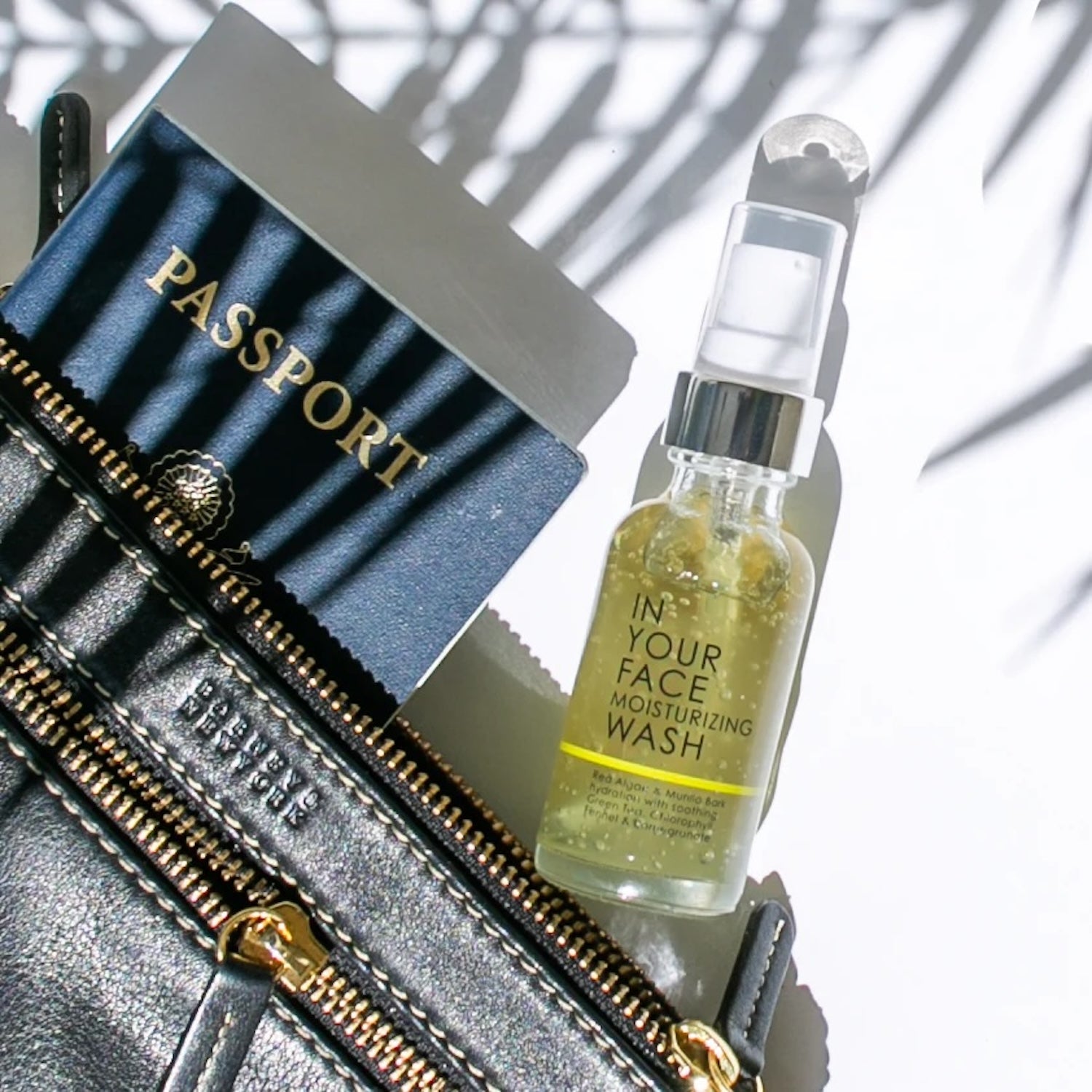 Compact In Your Face Moisturizing Wash Mini paired with a passport and travel essentials, emphasizing its TSA-friendly design for convenient skincare on the go.
