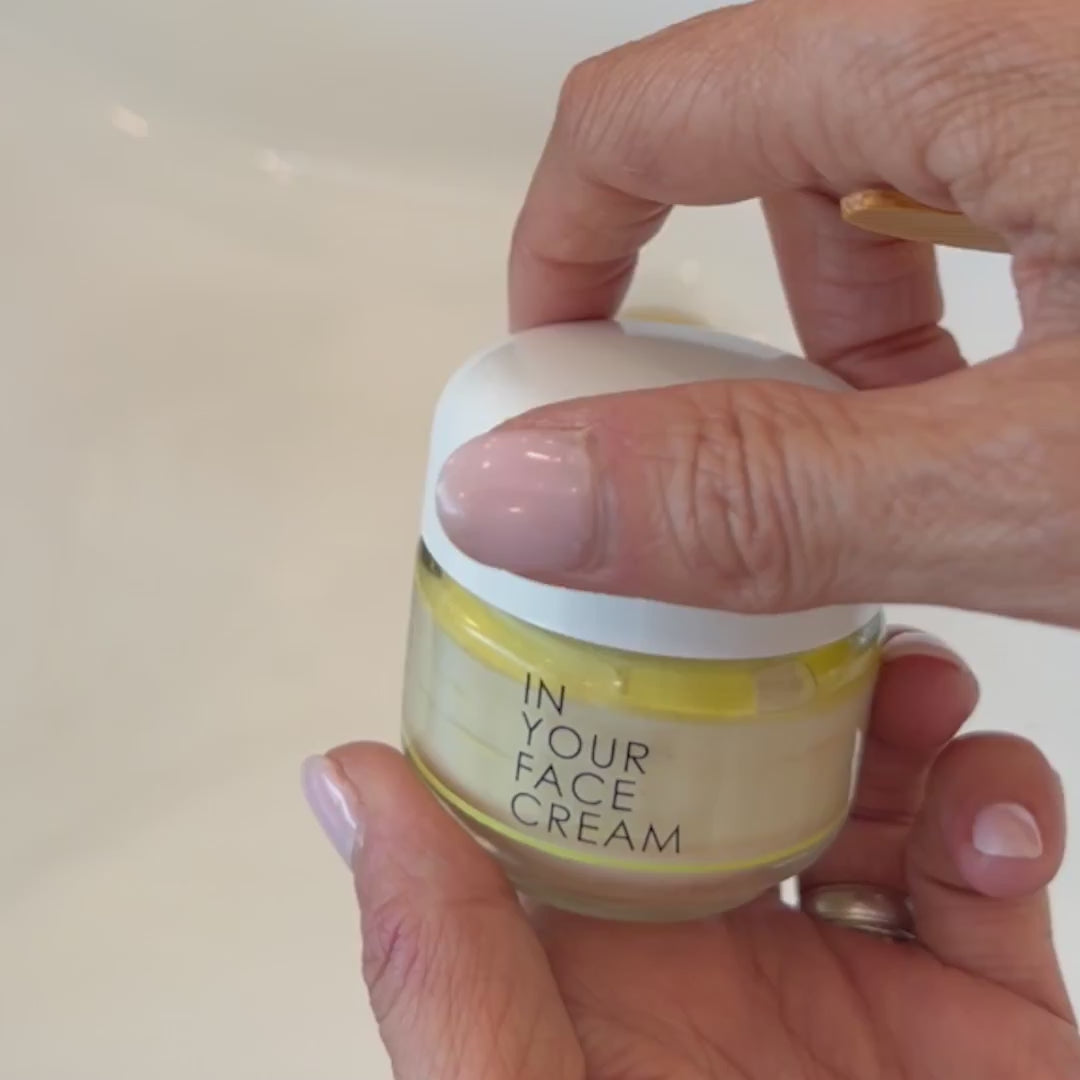 Video of In Your Face Cream in a glass jar, a luxurious moisturizer that hydrates and nourishes the skin with natural extracts.