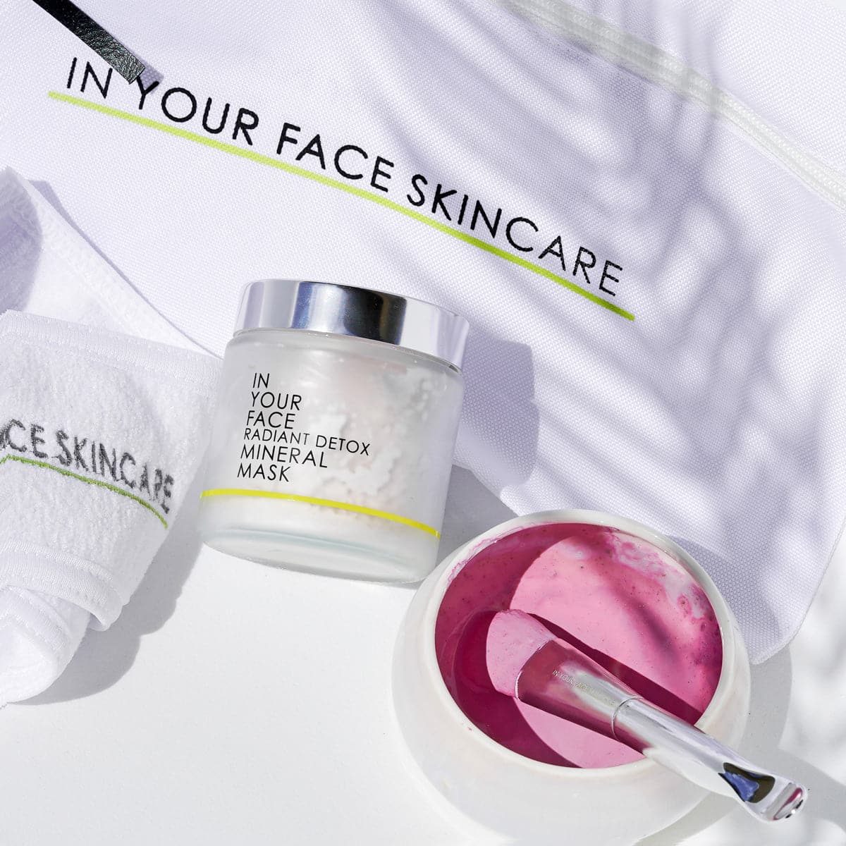 Skincare product with a pink mask and applicator on a white background, featuring 'In Your Face Skincare' branding.