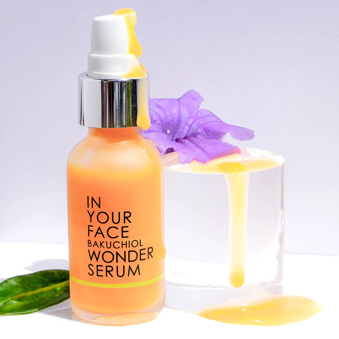 In Your Face Bakuchiol Wonder Serum in an orange glass bottle, formulated to promote youthful, radiant skin with natural botanicals.