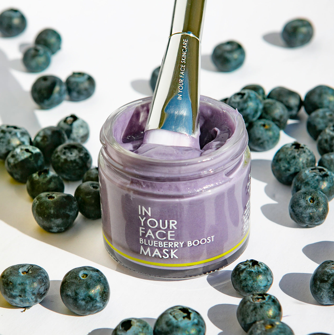 In Your Face Blueberry Boost Mask in a glass jar, enriched with antioxidant-rich blueberries for revitalizing and hydrating the skin.