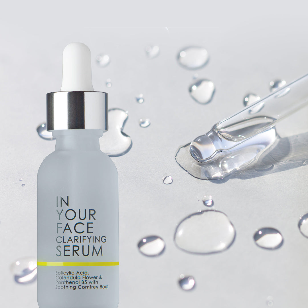 In Your Face Clarifying Serum in a frosted glass bottle, designed with salicylic acid and comfrey root to target blemishes.