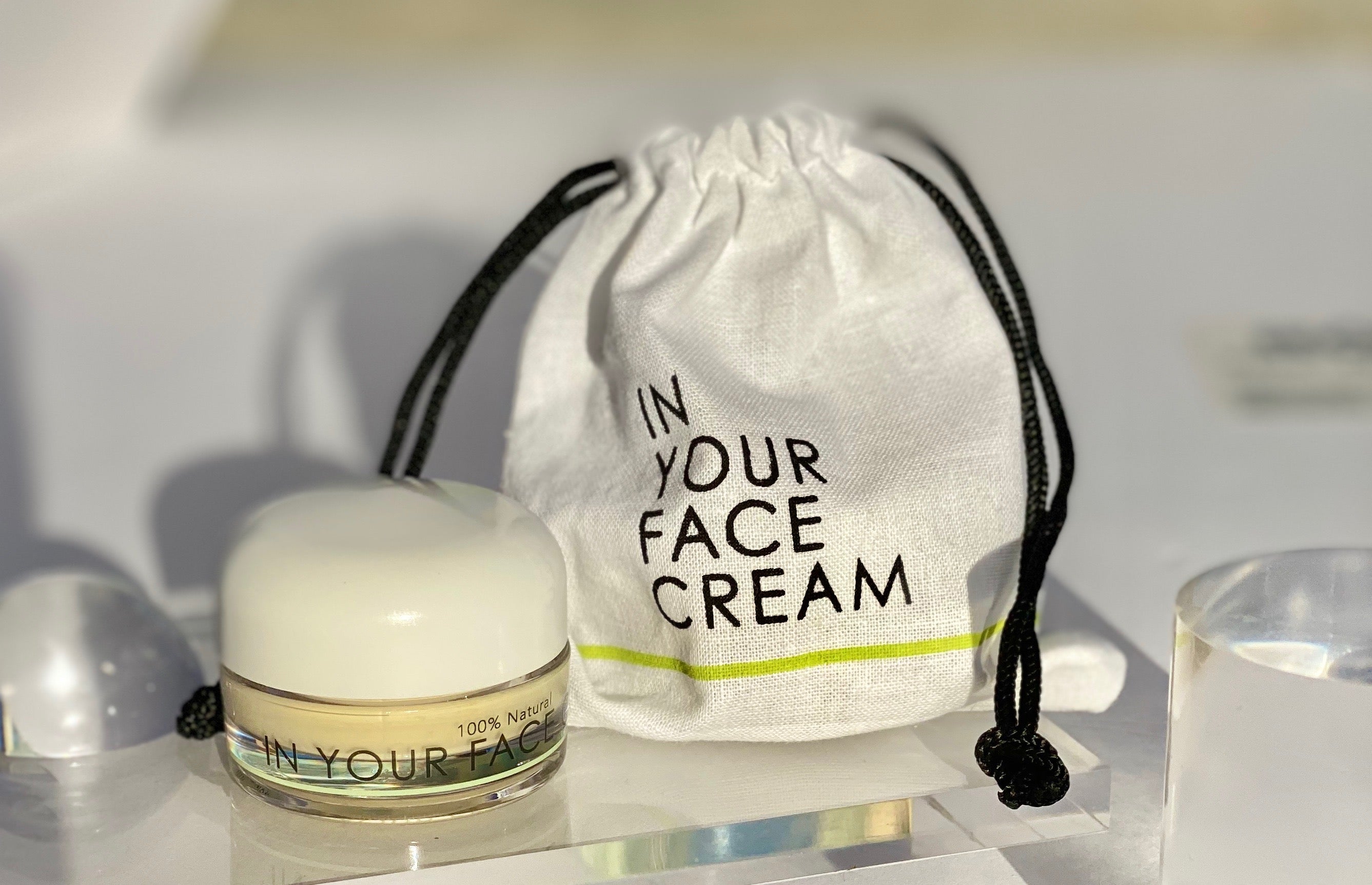 In Your Face Cream in a small glass jar with a white lid, formulated to provide intense hydration and nourishment for the skin.