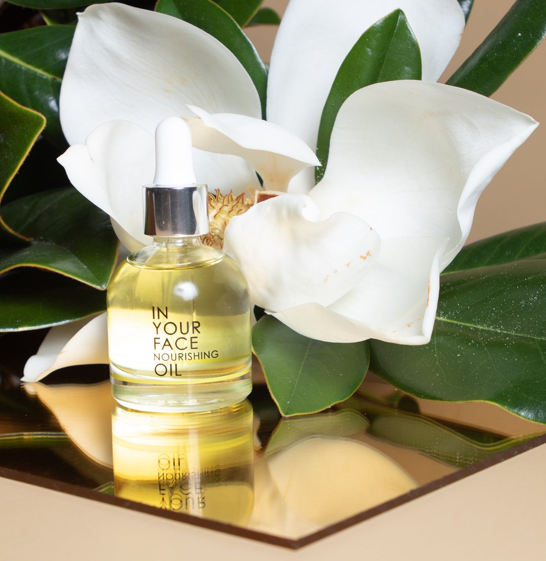 In Your Face Nourishing Oil in a glass bottle with a dropper, crafted to deeply nourish and hydrate the skin with natural oils.