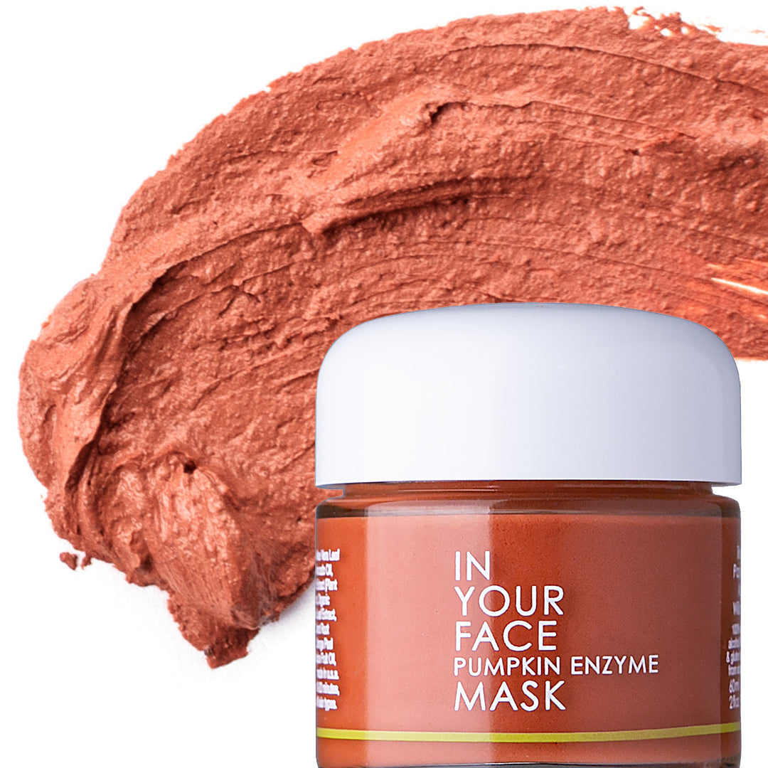 In Your Face Pumpkin Enzyme Mask in a small glass jar with a white lid, formulated to exfoliate and brighten the skin with pumpkin enzymes.