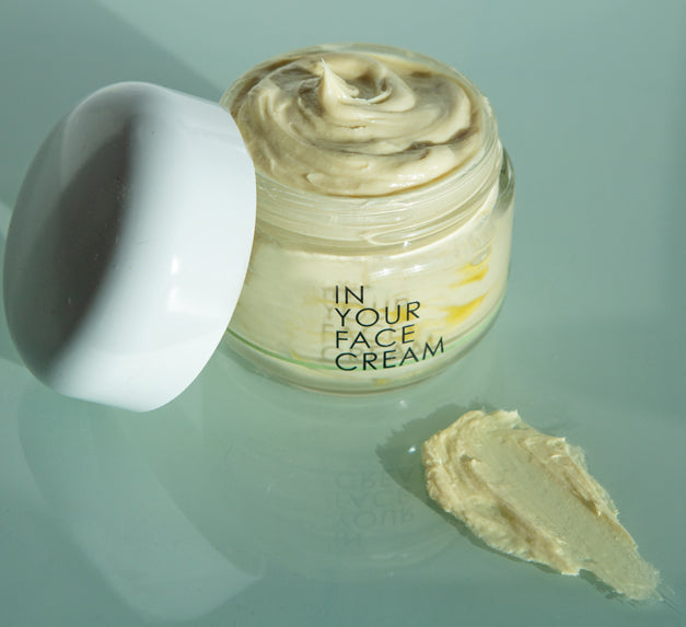 In Your Face Cream in a glass jar, a luxurious moisturizer that hydrates and nourishes the skin with natural extracts.