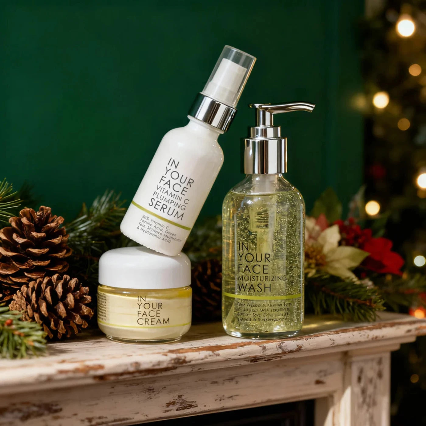 Four skincare products on a wooden surface with a festive background