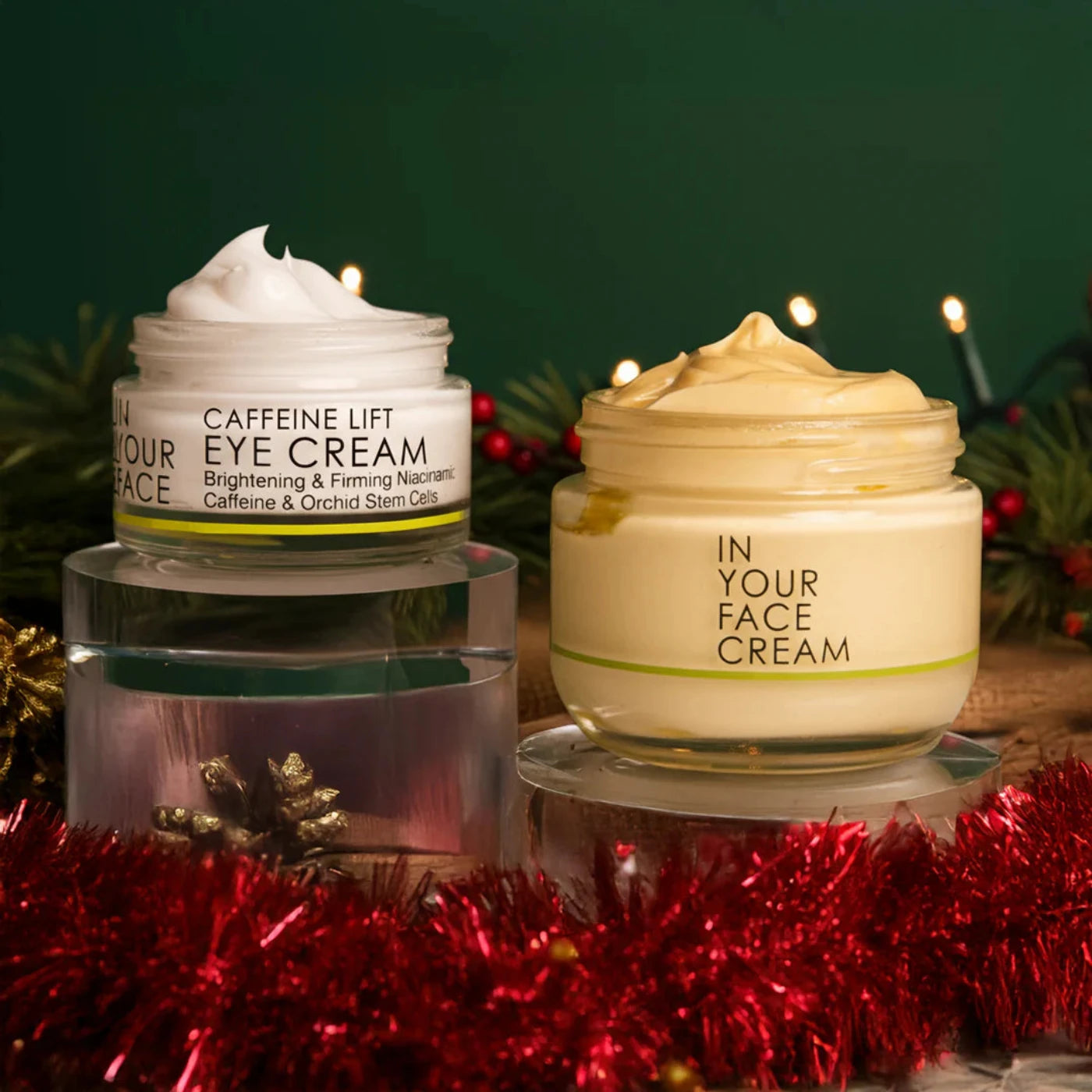 Two skincare cream jars with decorative Christmas elements in the background