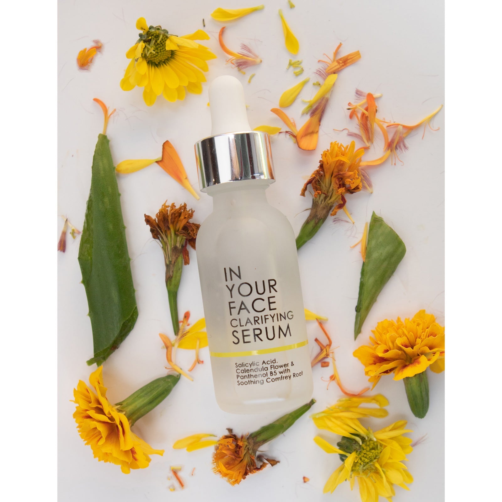 In Your Face Clarifying Serum in a frosted glass bottle, designed with salicylic acid and comfrey root to target blemishes.