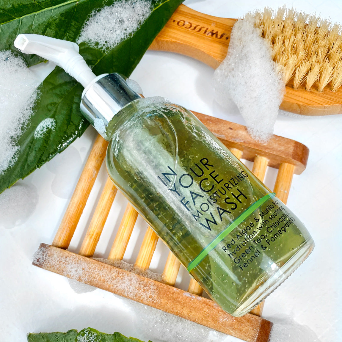 In Your Face Moisturizing Wash in a clear bottle with a pump, offering hydration with natural ingredients for a soft and clean skin feel.